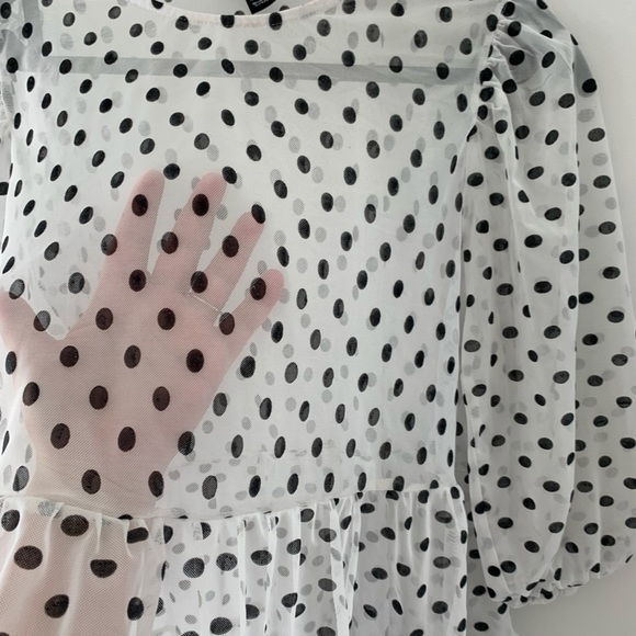 Mesh polka dot peplum, puff sleeve top in black and white. - Picture 2 of 3